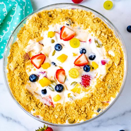 An overhead picture of the finished Cheesecake Fruit Salad iin a glass serving bowl.