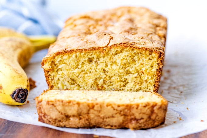 A loaf of banana bread with a slice cut off of it.