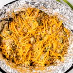 Top with cracker crumbs and shredded cheese.