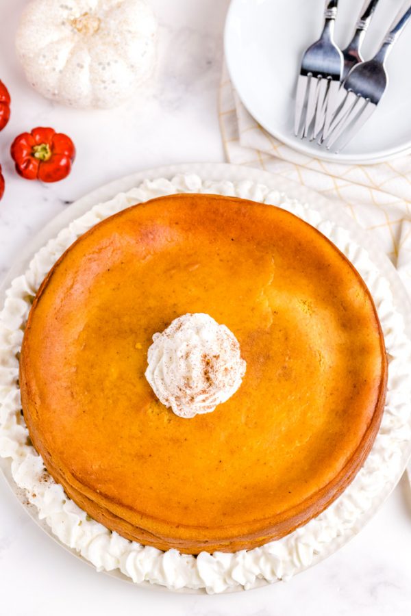 An overhead picture of the cheesecake garnished with whipped cream.