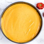 The cheesecake filling inside of the springform pan before it's baked.