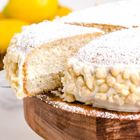 A slice of cake being taken out of the whole cake.