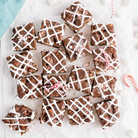 An overhead picture of sliced Christmas Rocky Road Fudge that's drizzles with marshmallow creme and crushed candy canes.