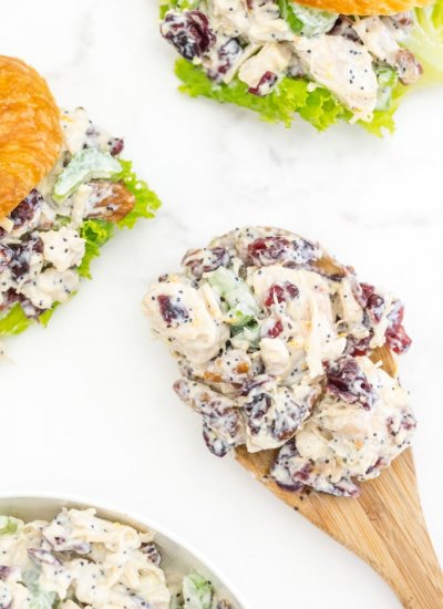 An overhead picture of chicken salad on a wooden spoon.