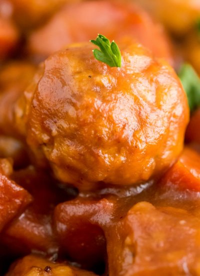 A close up picture of a crockpot cranberry meatball.