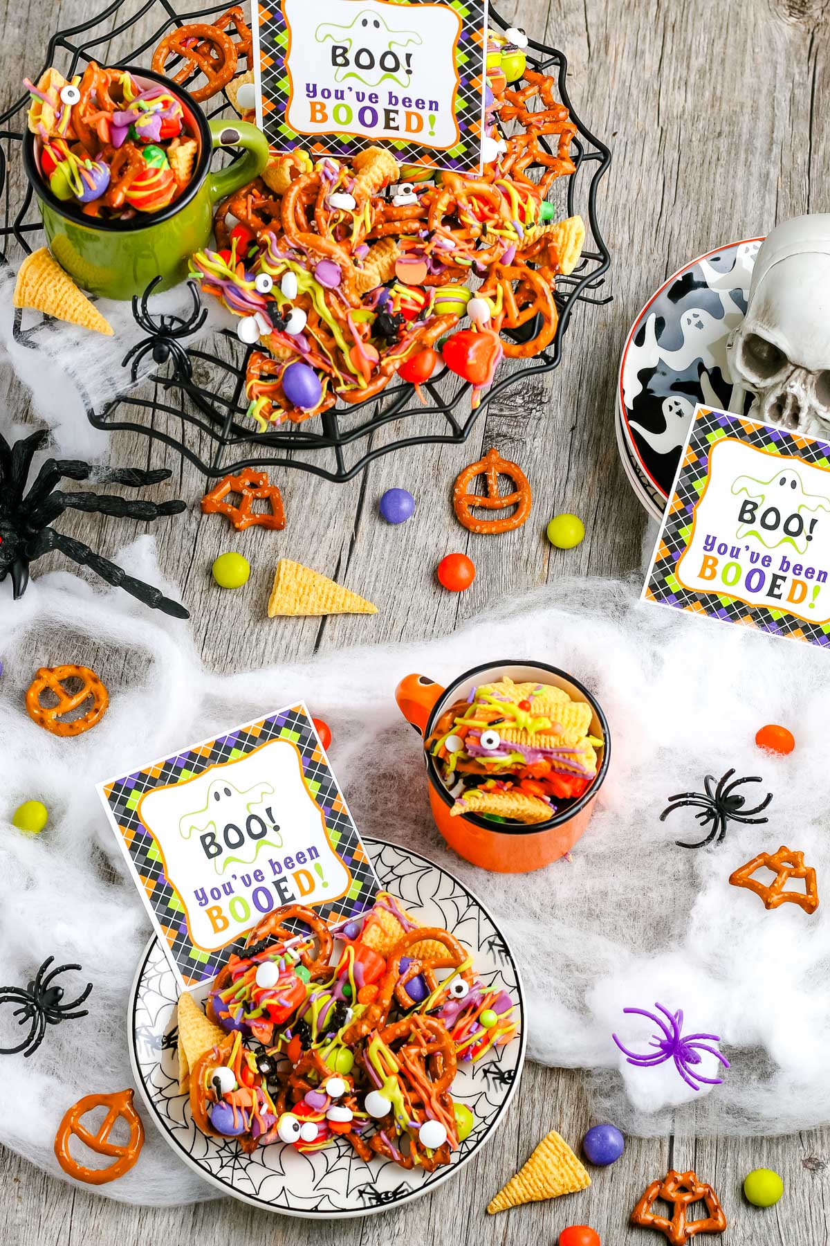 Halloween Snack Mix in serving bowls with gift tags nearby.