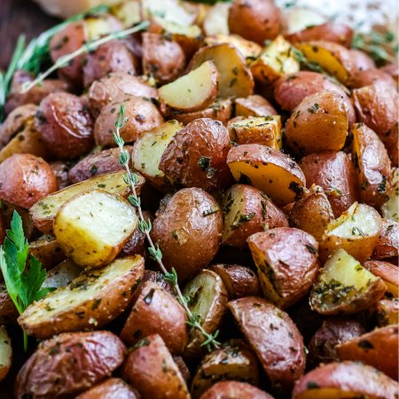 A close up picture of roasted red potatoes straight from the oven.