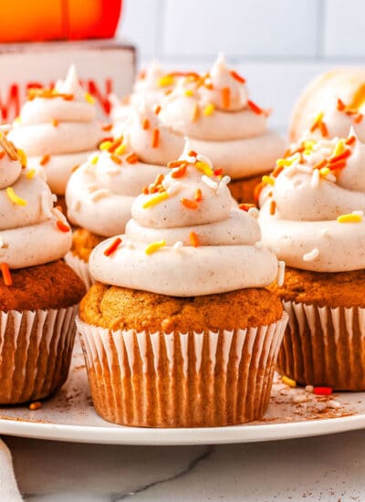 pumpkin cupcakes with cream cheese frosting on a plate