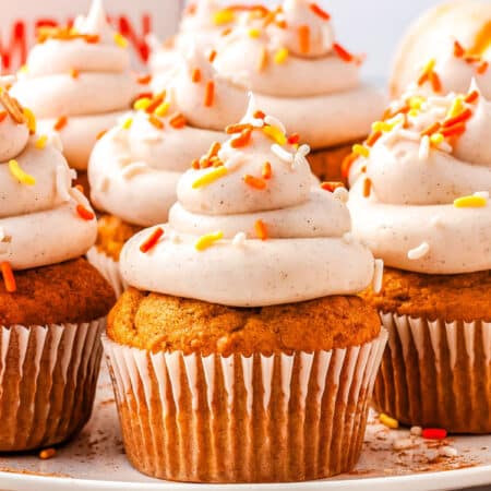pumpkin cupcakes with cream cheese frosting on a plate