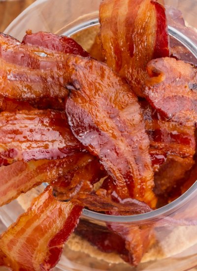 The candied bacon sticking straight up in a clear glass.
