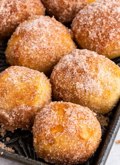 A close up picture of cinnamon sugar pretzel bites on a baking sheet.