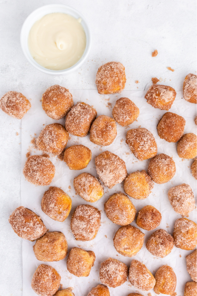 An overhead picture of cinnamon sugar pretzel bites on parchment paper. 