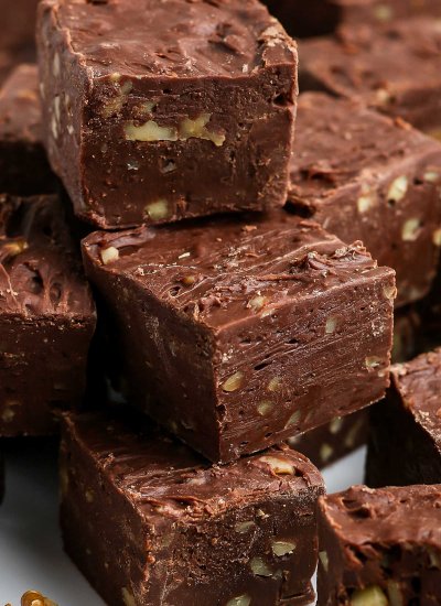 A close up picture of easy chocolate fudge stacked on each other.