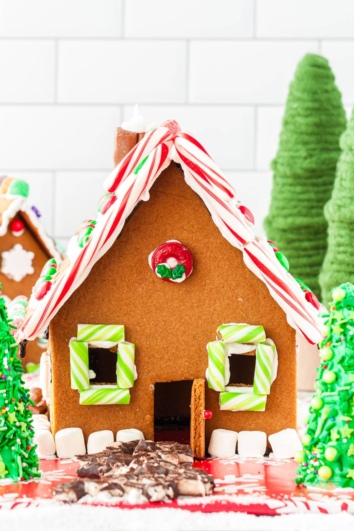 A close up of a finished large homemade gingerbread house.