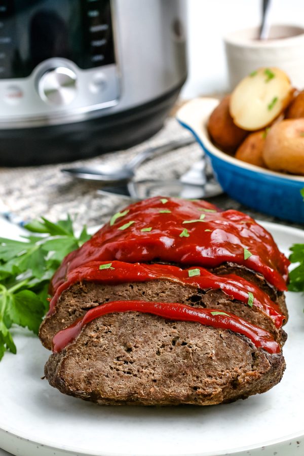 The finished Instant Pot Meatloaf and potatoes with the instant pot in the background. 