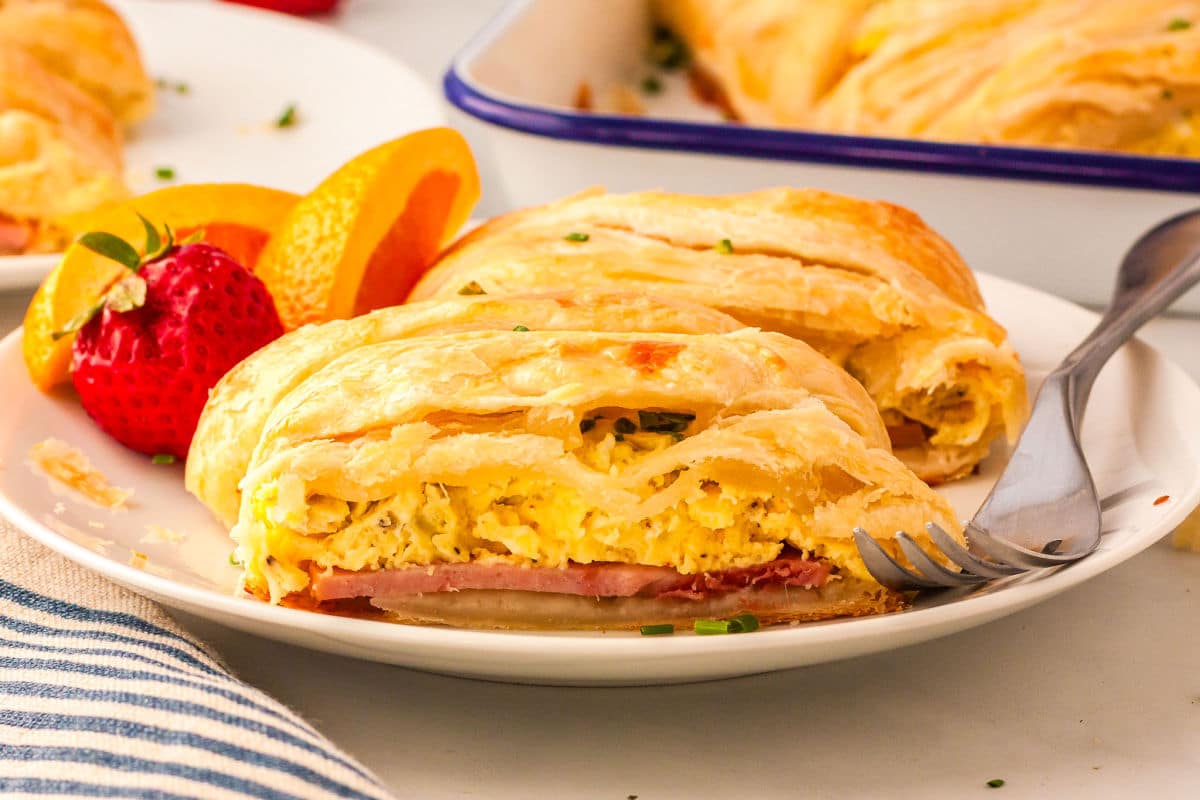 a slice of eggs benedict braid on a plate