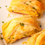 a slice of the eggs benedict braid on a baking sheet