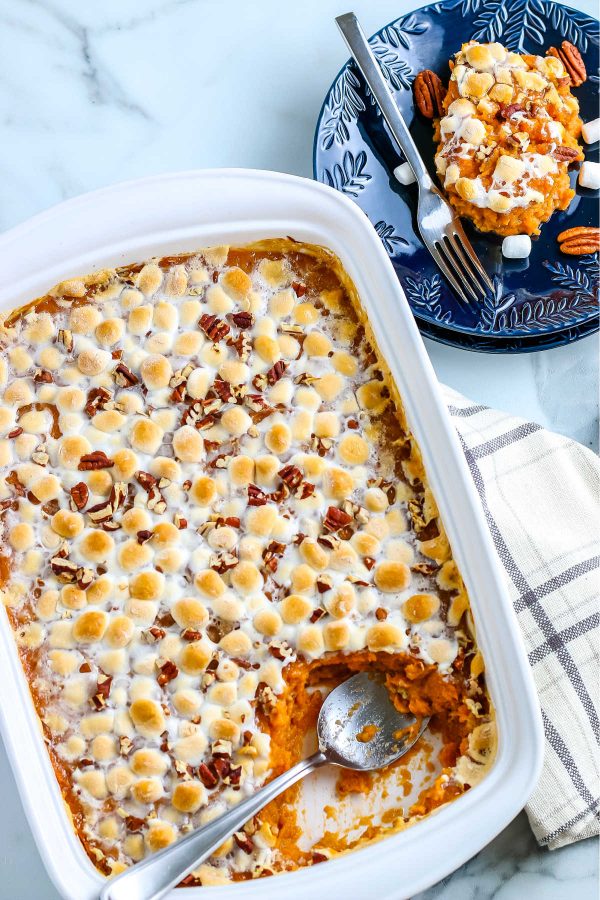 An overhead picture of sweet potato casserole with marshmallows and pecans.