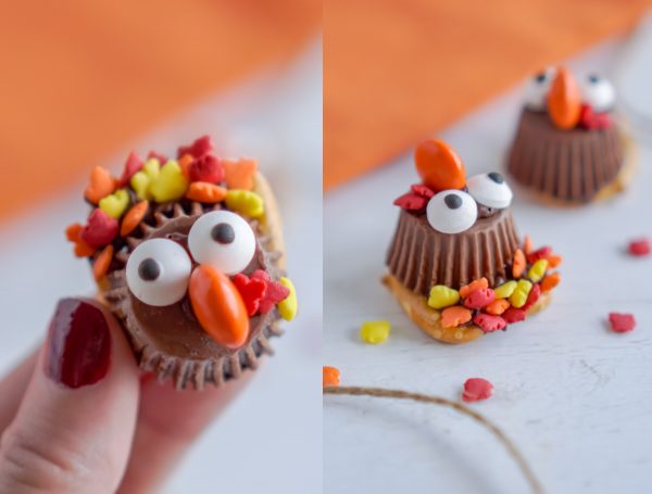 A hand picking up a turkey treat made with leaf sprinkles.