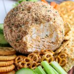 The finished classic cheese ball on a serving plate with veggies.