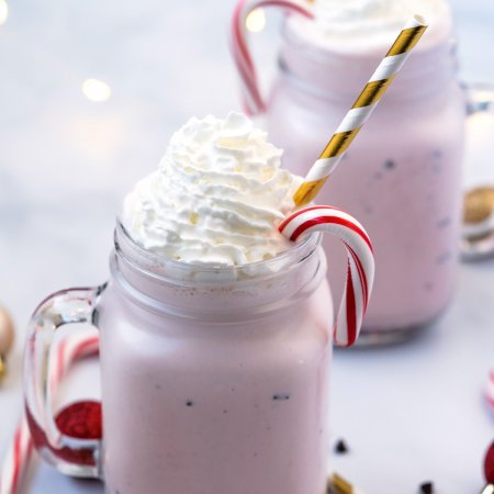 The finished Chick Fil A Peppermint Shake in a mug with a straw.