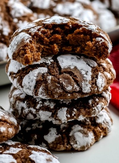 A close up picture of a stack of chocolate crinkle cookies.