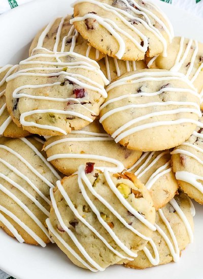 An overhead picture of cranberry pistachio cookies on a white plate.