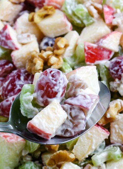 A spoon scooping up some of the Waldorf Salad.