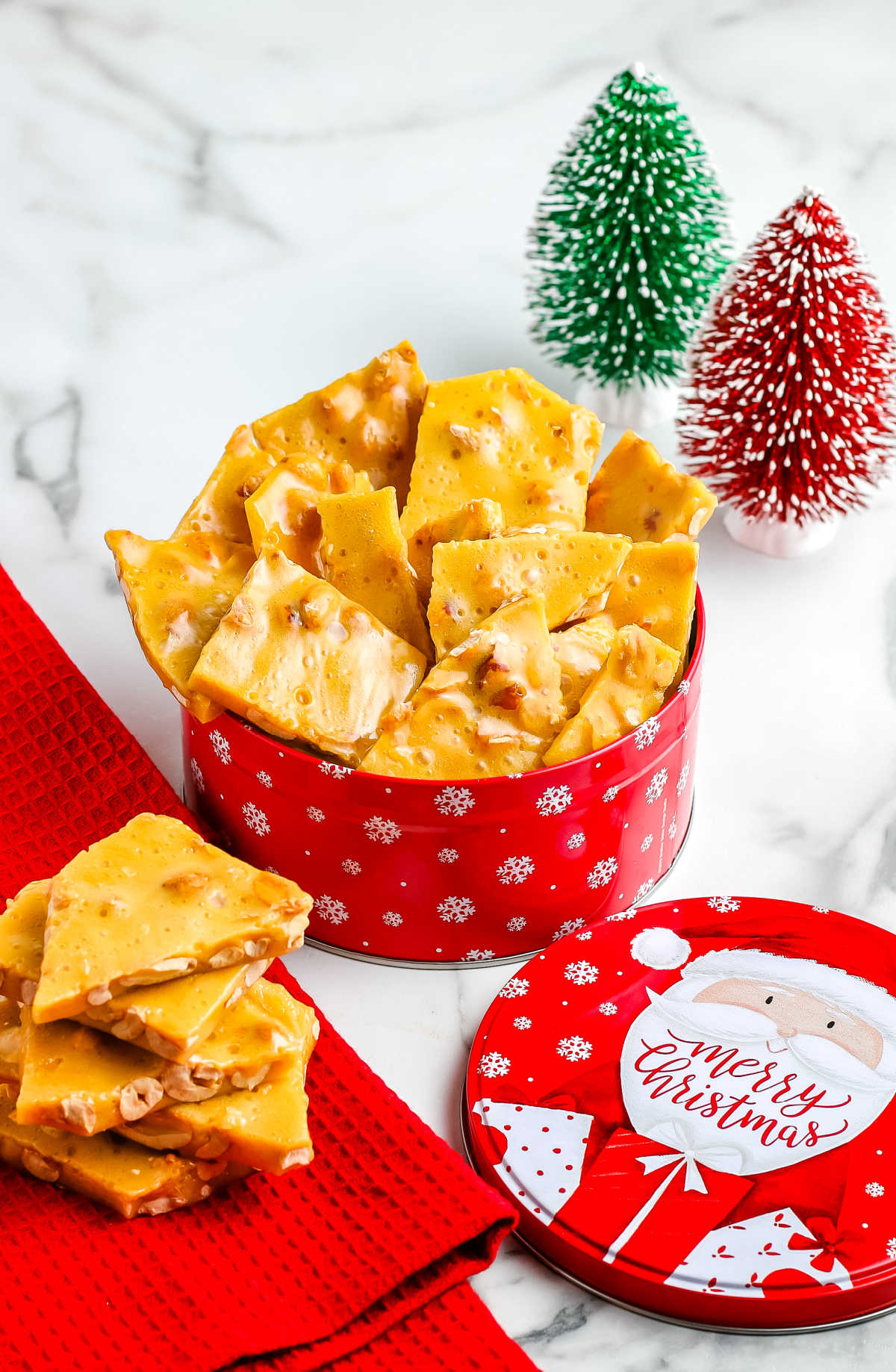 Old fashioned peanut brittle in a decorative tin for gifting.
