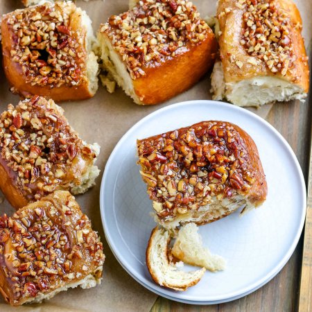 An overhead picture of a sticky bun on a white plate.