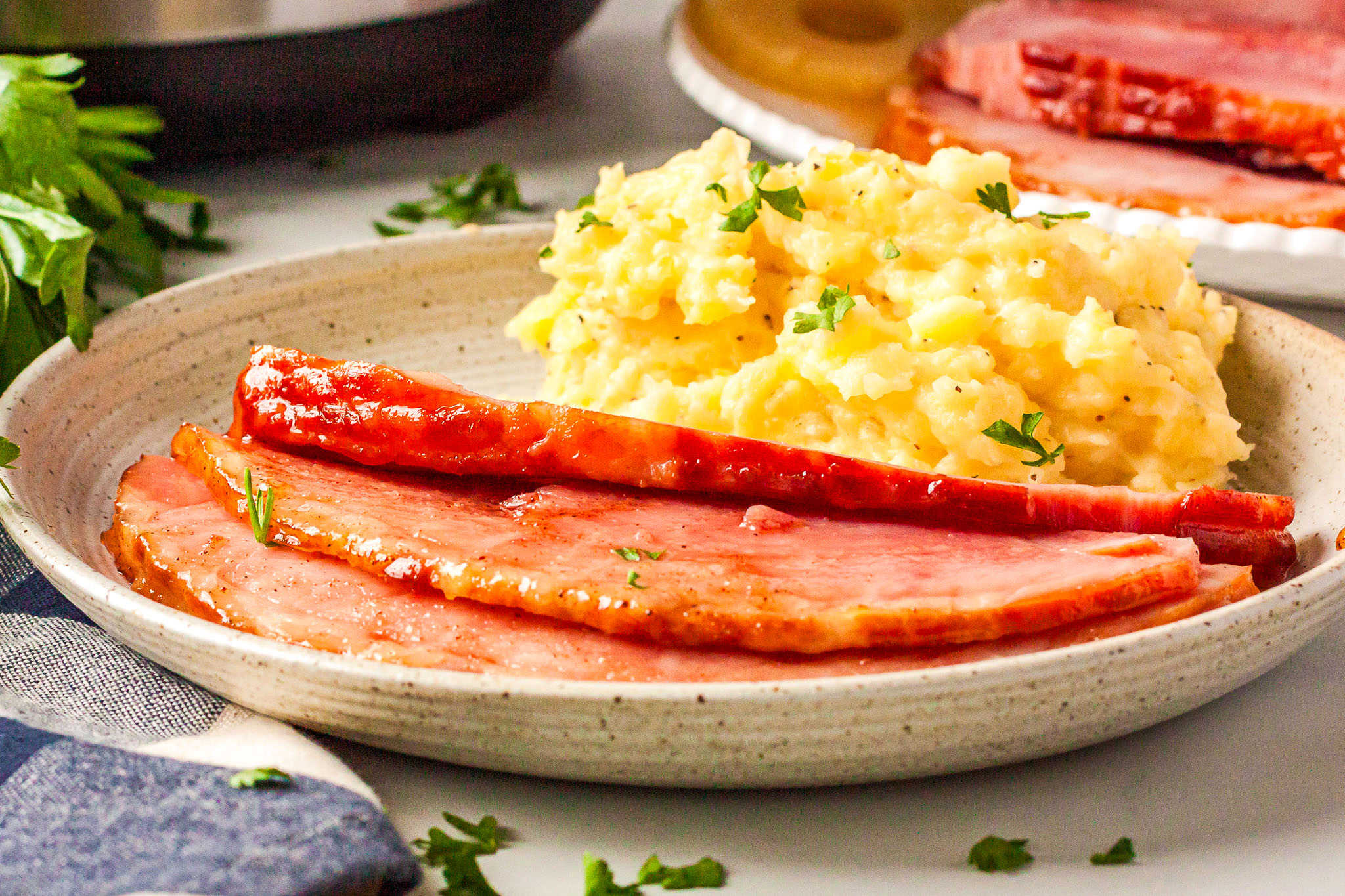 ham slices on a plate with mashed potatoes