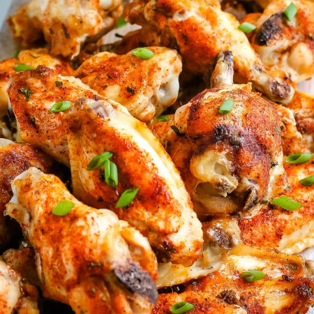 Baked Chicken Wings stacked onto a platter.