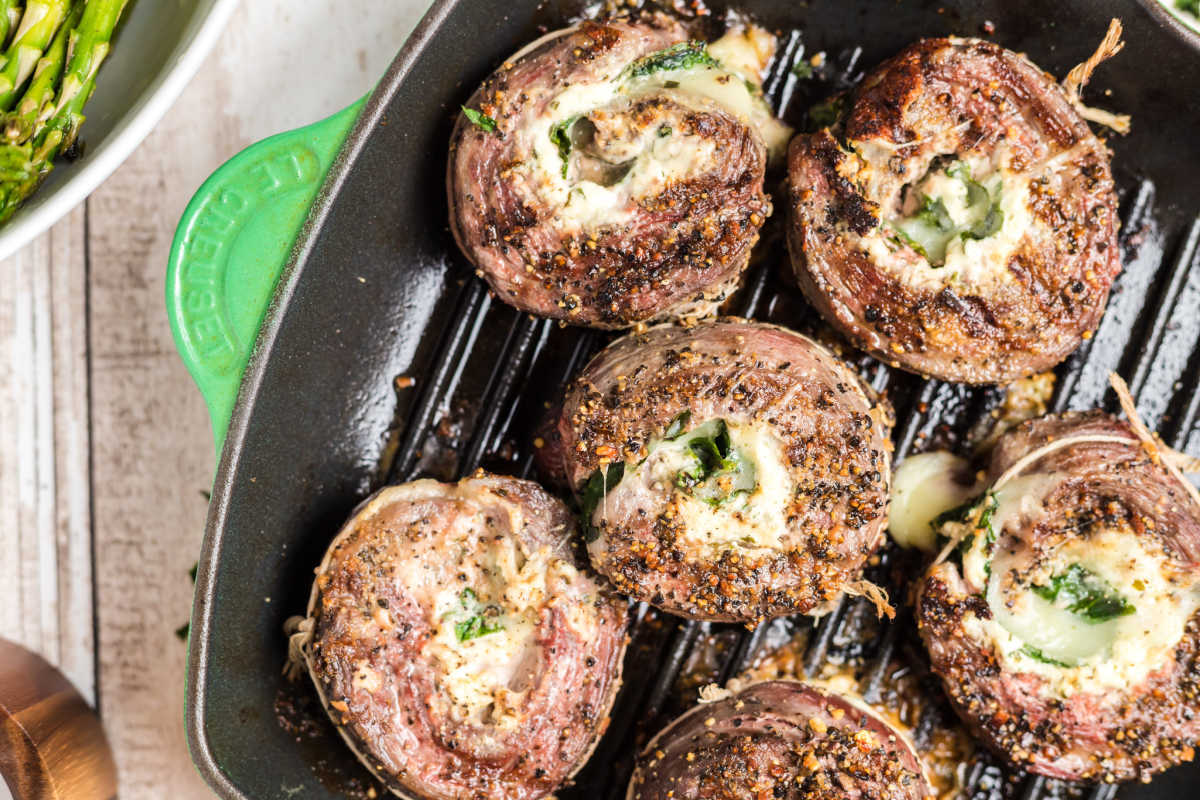 Six Flank Steak Pinwheels in a pan.
