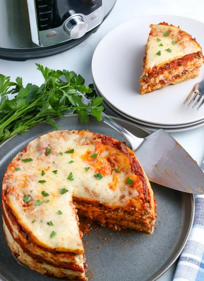An overhead picture of the finished Instant Pot Lasagna with a piece taken out of it.