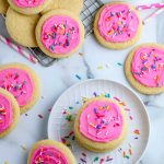 An overhead picture of Copycat Lofthouse Sugar Cookies with pink frosting and sprinkles.