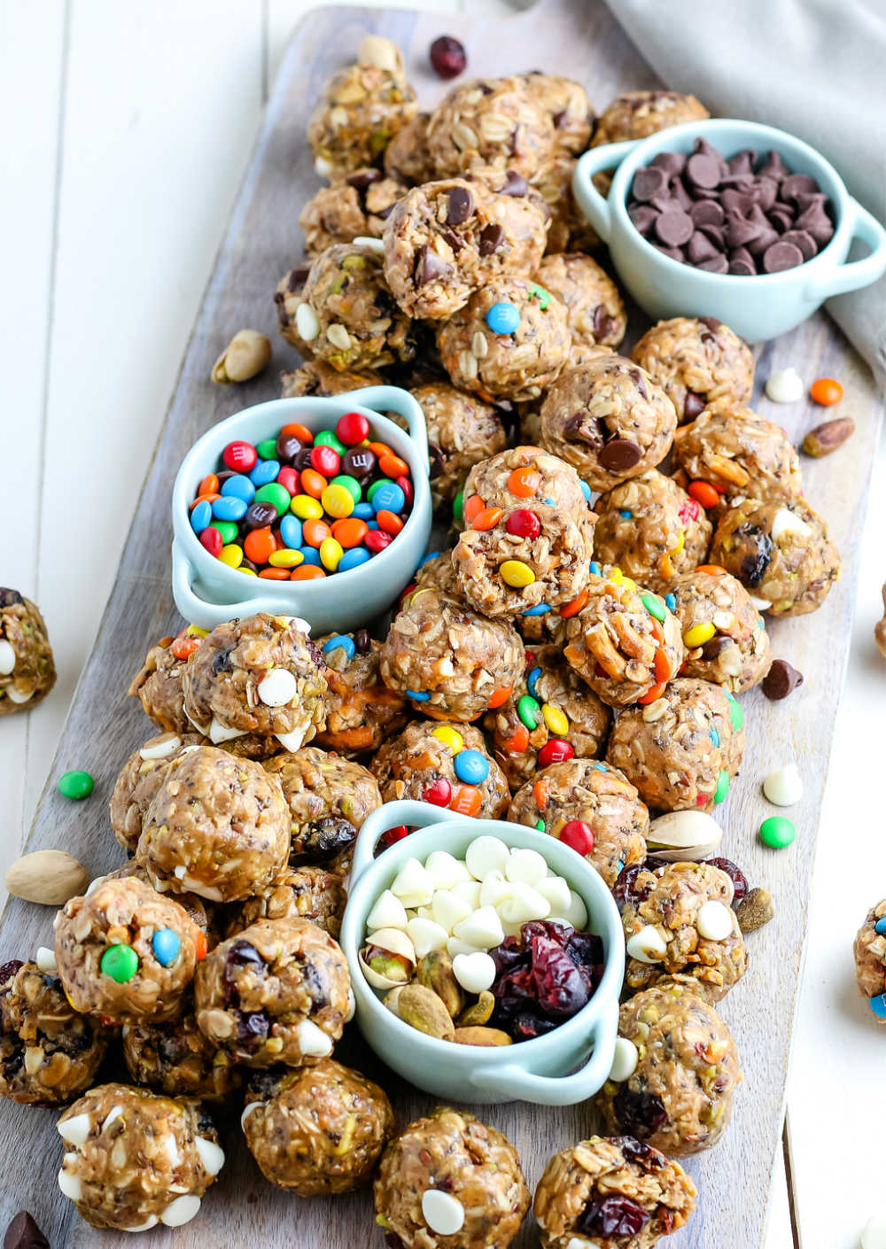 Energy balls on a wooden serving platter.
