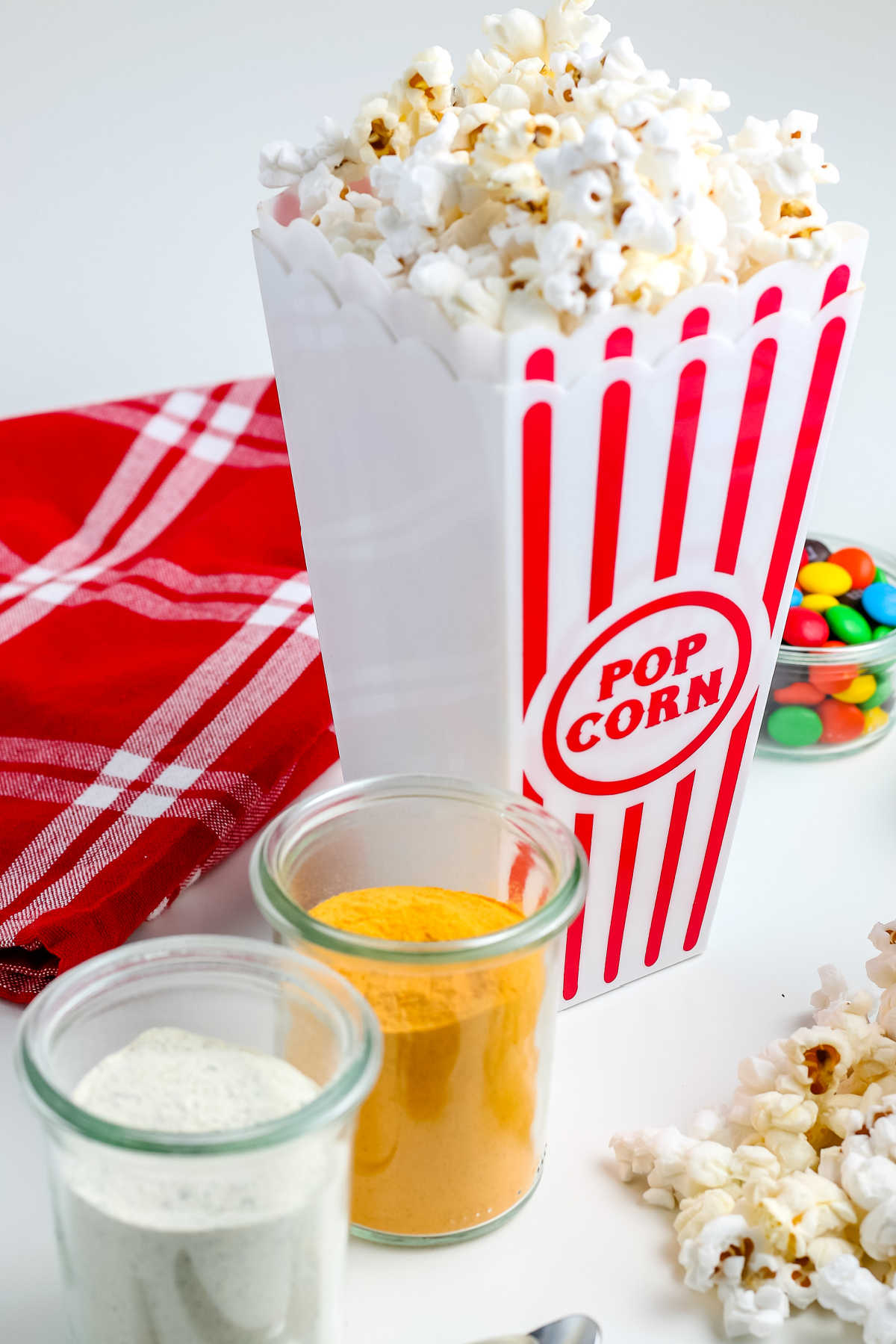 The finished Instant Pot Popcorn in a red and white popcorn container. 
