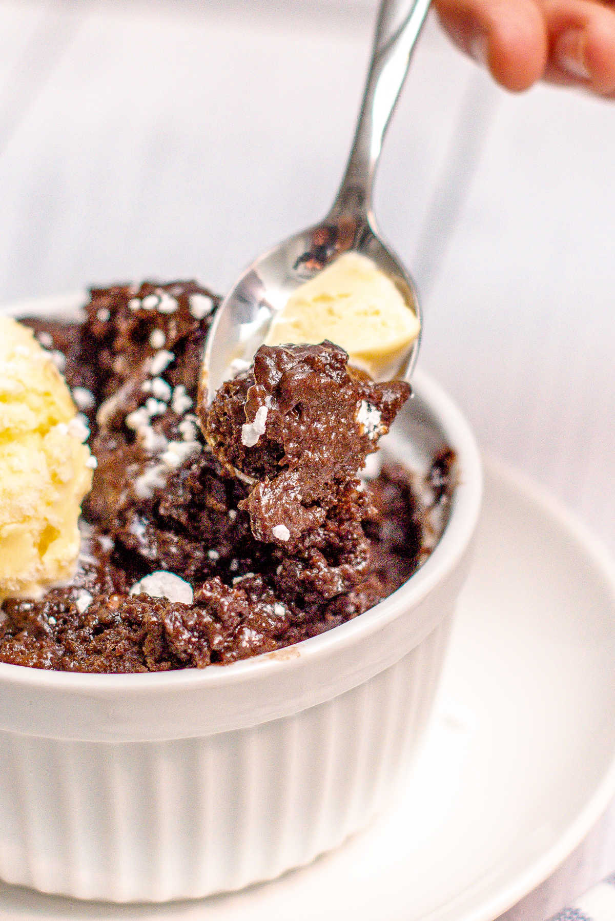 lava cake in a bowl with a scoop of vanilla ice cream.