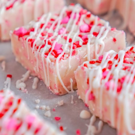 A close up picture of Easy Valentine's Day Fudge after it's drizzled with white chocolate.
