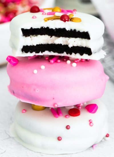 Three White Chocolate Dipped Oreos stacked on top of each other.