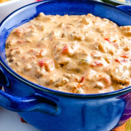 Chile Con Queso in a blue serving bowl.
