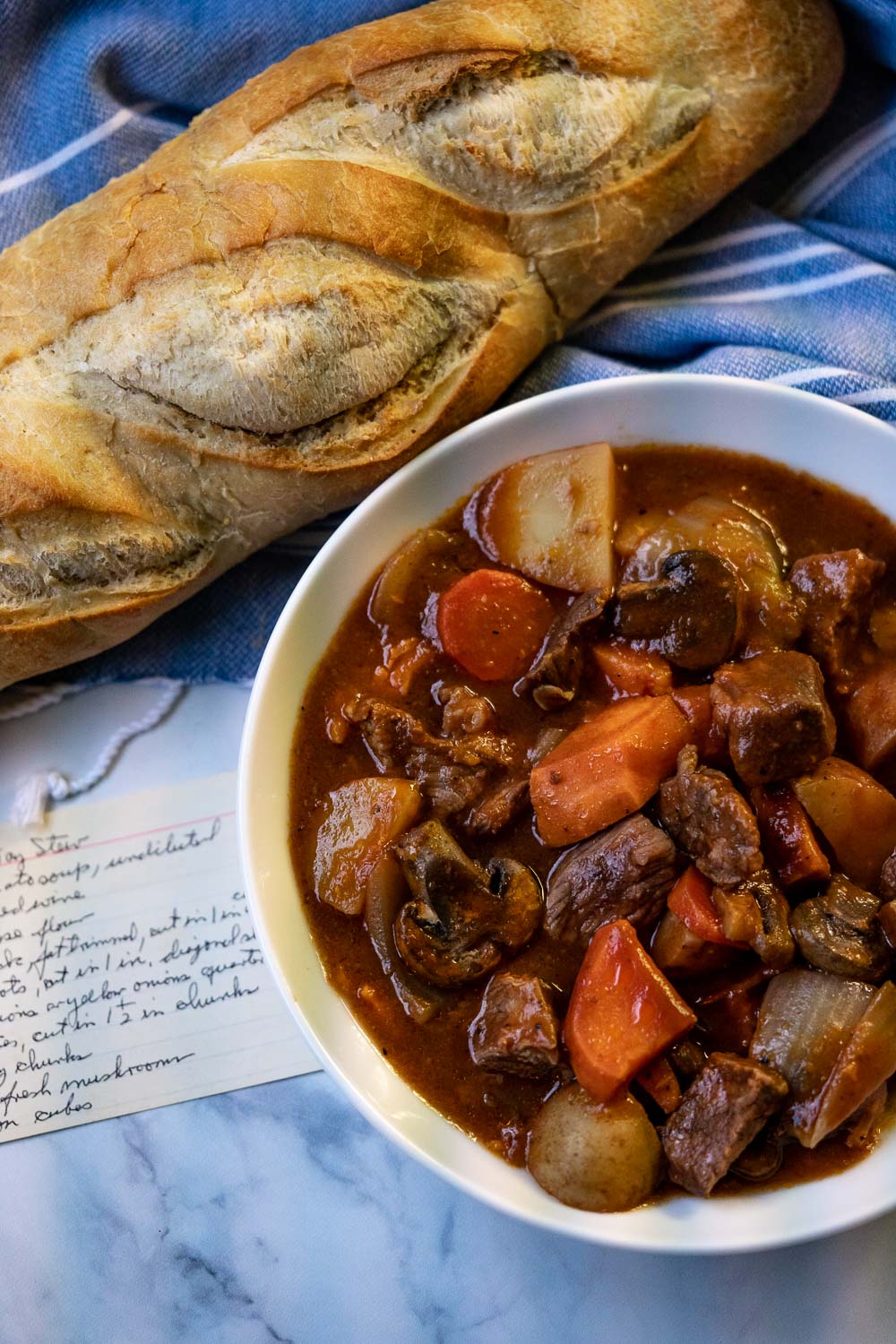 The finished Gone All Day Stew with grandpa's handwritten recipe on an index card.