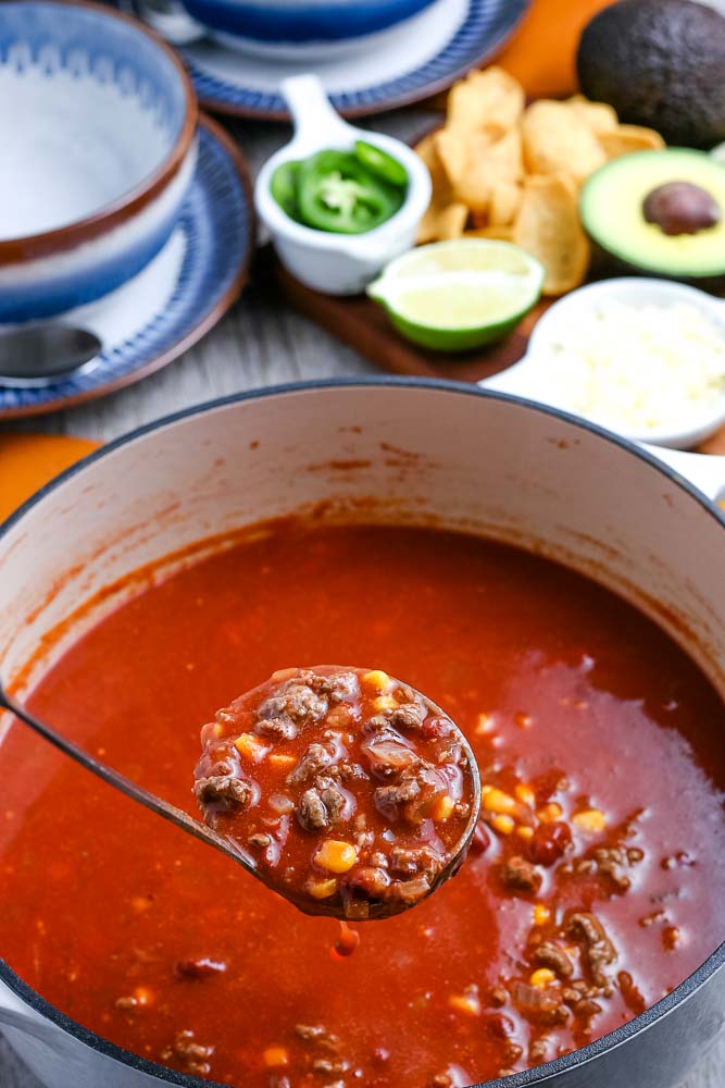 A ladle picking up some Taco Soup.