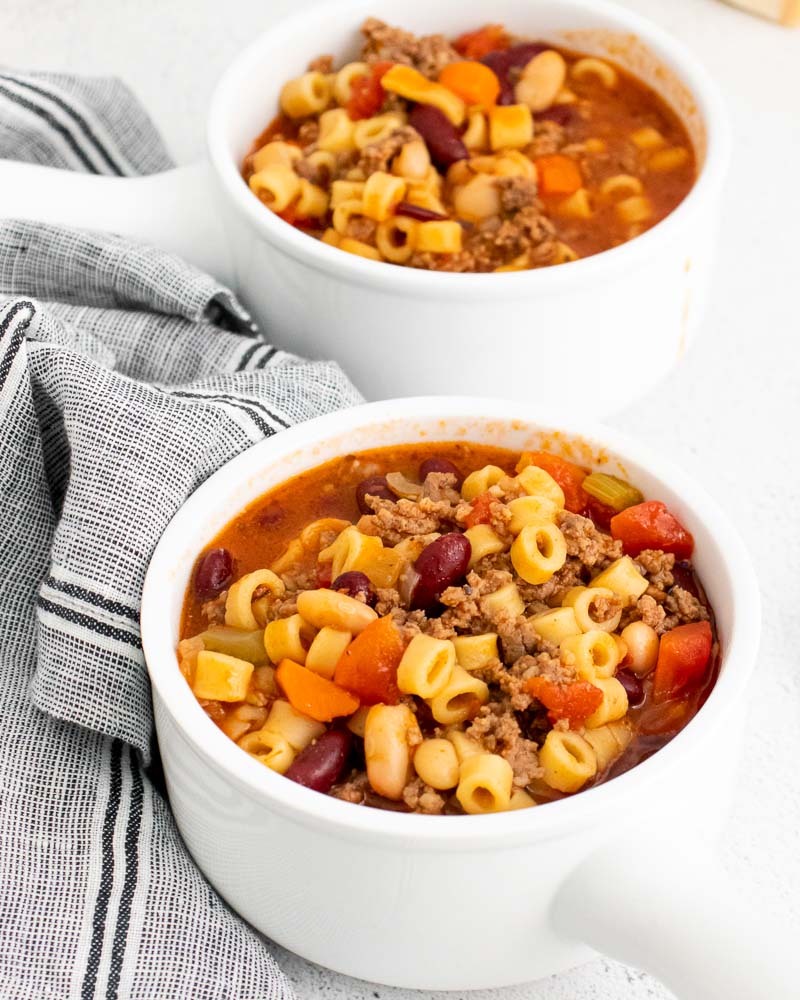 The finished Olive Garden Pasta e Fagioli Soup Copycat recipe in white soup bowls. 
