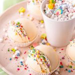 A close up picture of Rainbow White Hot Chocolate Bombs on a serving platter.