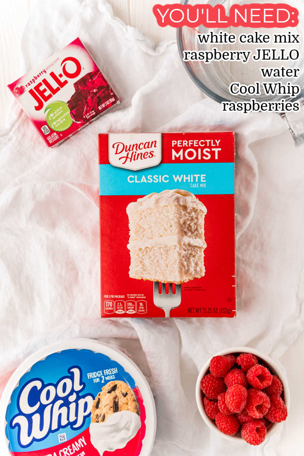 An overhead picture of all of the ingredients needed to make Raspberry Jello Poke Cake. 