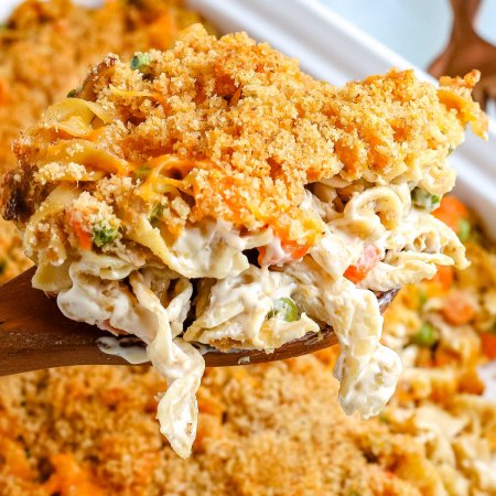 A close up picture of a spoon picking up some of the Tuna Noodle Casserole.