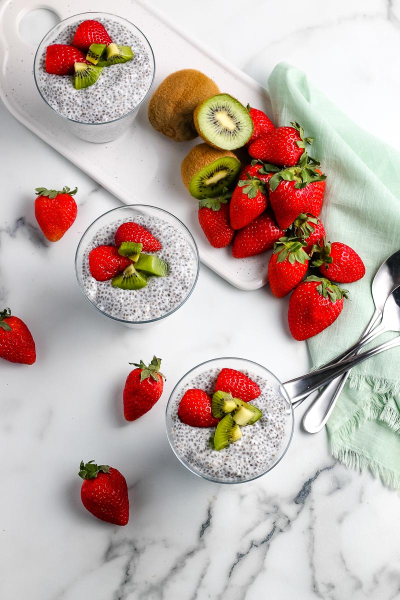 An overhead picture of the finished Chia Seed Pudding surrounded by strawberries and kiwi.