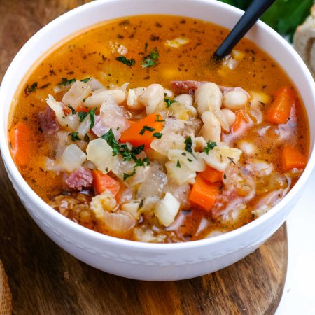 A close up picture of Ham and Bean Soup in a white bowl.