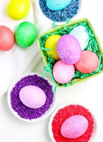 An overhead picture of dyed Easter eggs in a bowl and in dishes.